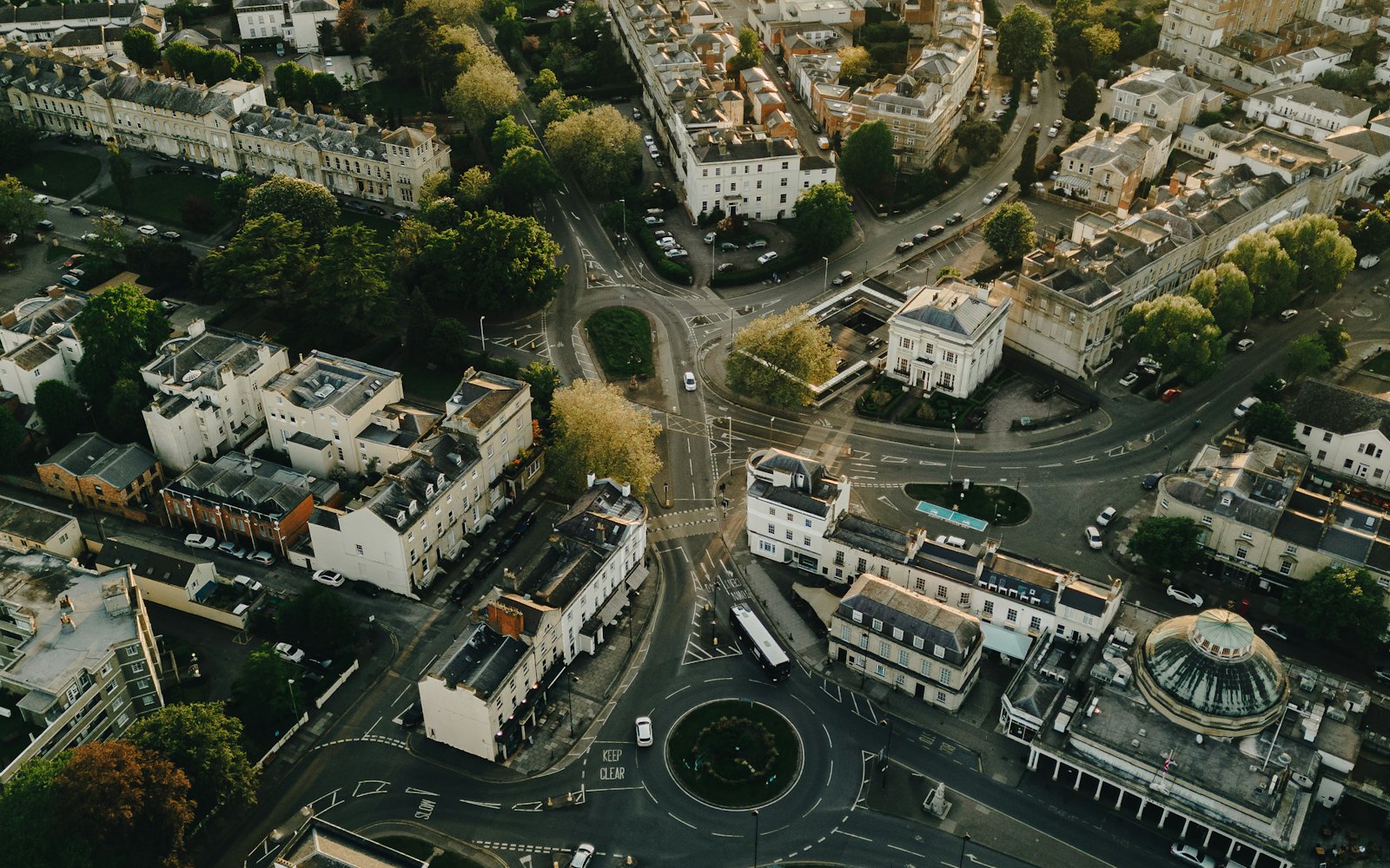 Aerial view of Cheltenham town centre, with pale Regency terraces and tree-lined streets