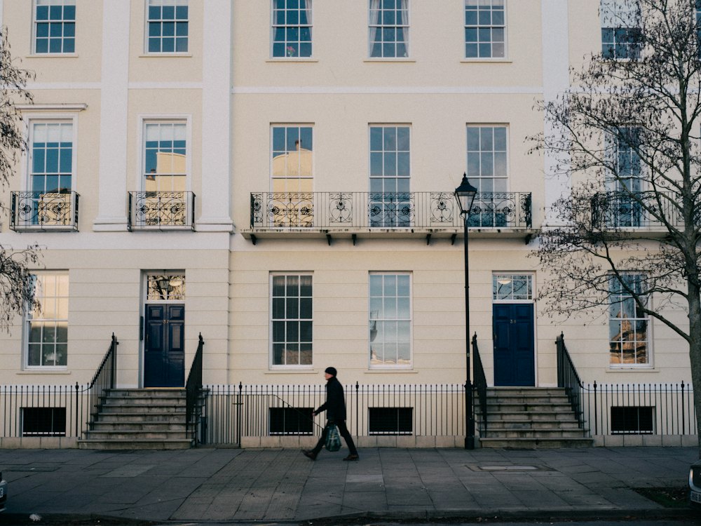 A cream Regency terrace with tall sash windows and steps up to two front doors